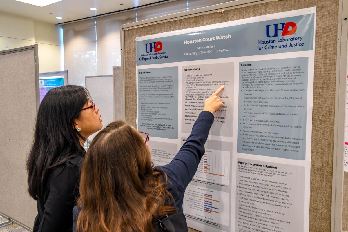 Amy Sanchez (center) explains her observations to Dr. Fei Yang.